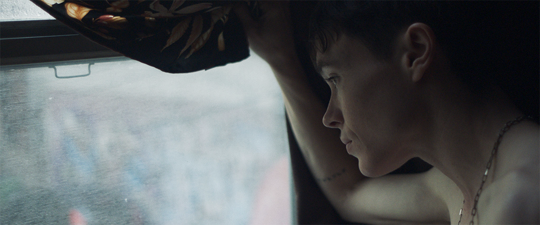 Elliot Page and Hillary Baack sharing a poignant moment, their expressions a mix of nostalgia and complexity, against a backdrop that hints at their shared past.