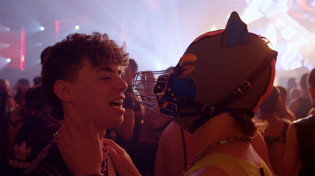 A dynamic and atmospheric shot from 'Darklands', capturing the essence of the festival with vivid scenes of attendees in various expressions of their kink identities.