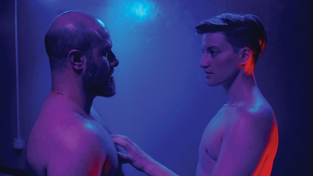 A mystical and intriguing scene from 'Desire Lines', showing Ahmad exploring the dimly lit archives that transform into a mythical bathhouse.