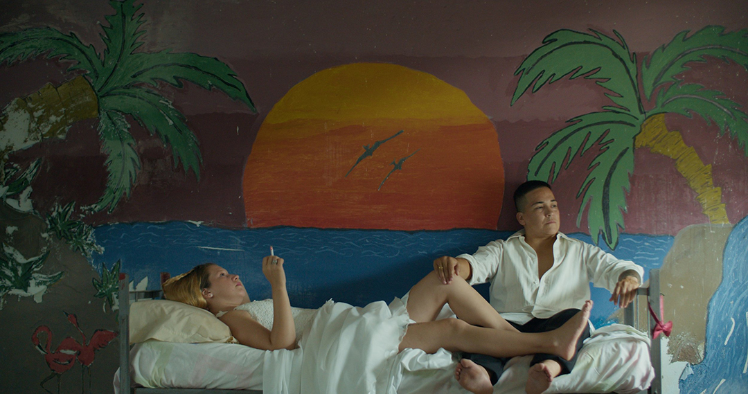 A poignant scene from 'Reas', showcasing a diverse cast of formerly incarcerated individuals, engaged in a powerful musical performance within the walls of an abandoned Buenos Aires prison.