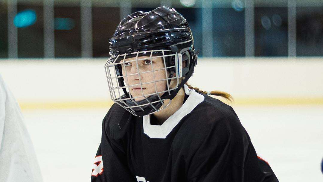 A compelling image of Manon Rivière in her ice hockey gear, poised and determined on the rink, with the stark cold atmosphere reflecting her personal struggles and ambitions.